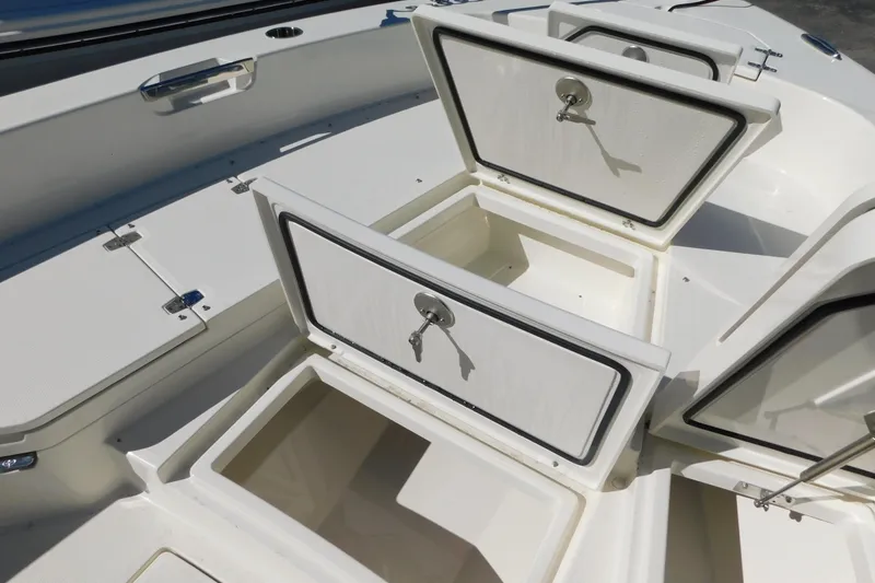 Slide: The Image of 2026 Pathfinder 2600 TRS boat storage compartments with secure locks. - 35