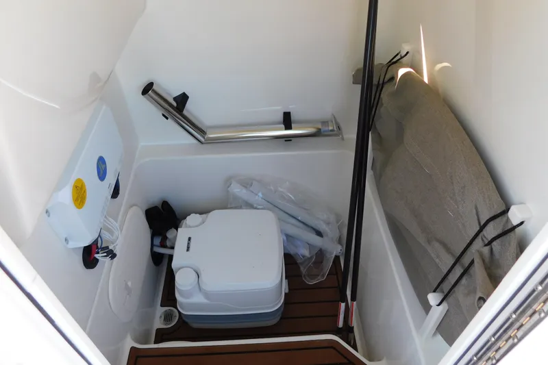 Slide: The Image of Interior of 2026 Pathfinder 2600 TRS boat with portable toilet and storage area. - 39