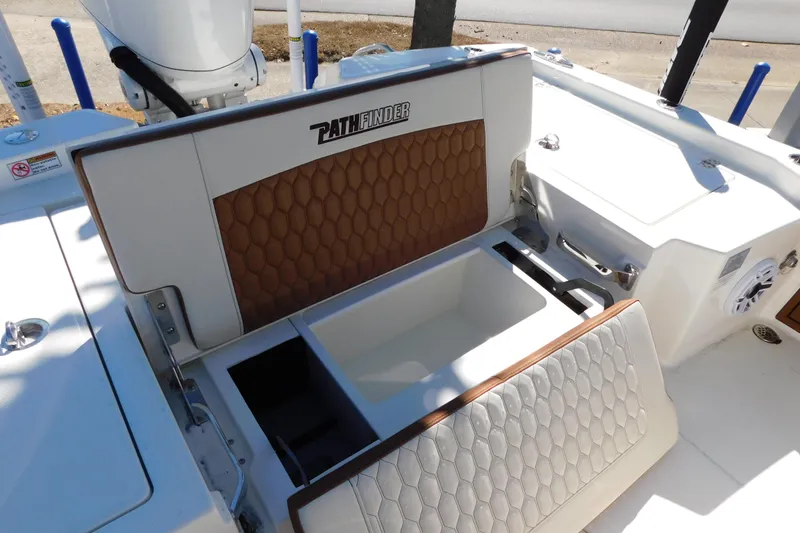 Slide: The Image of 2026 Pathfinder 2600 TRS boat interior with open storage compartments and stylish seating. - 44