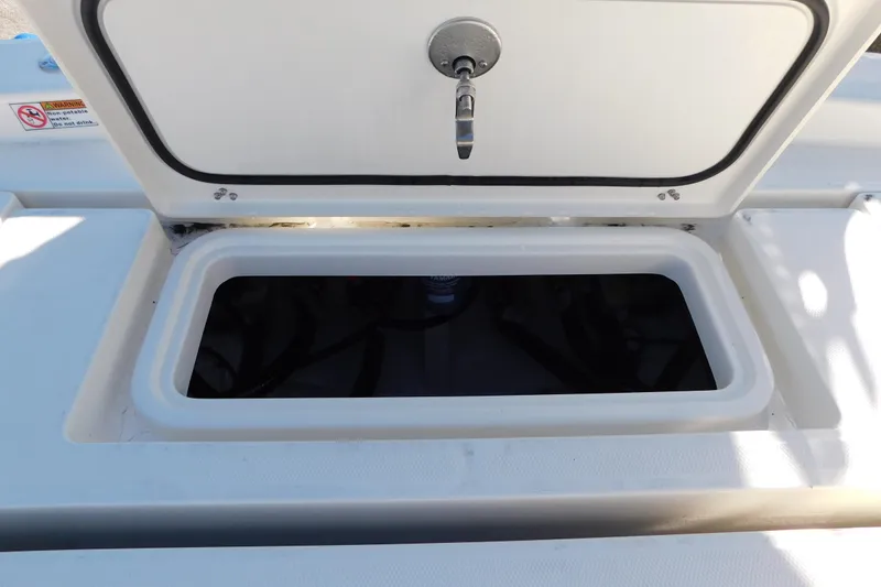 Slide: The Image of Open storage compartment on 2026 Pathfinder 2600 TRS boat deck. - 49