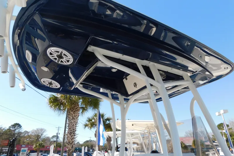Slide: The Image of 2026 Pathfinder 2600 TRS boat underside view with speakers, against a clear blue sky. - 58