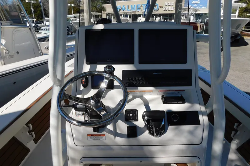 Slide: The Image of 2026 Pathfinder 2600 TRS boat console with dual screens and steering wheel. - 6