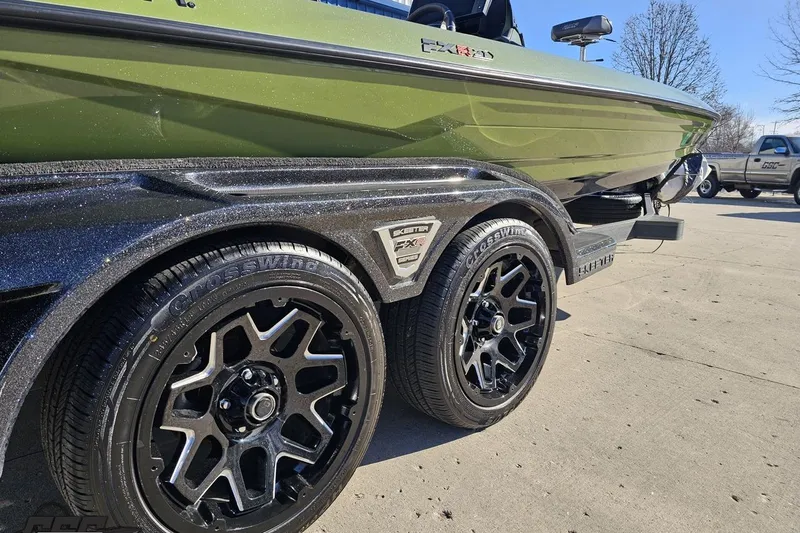 Slide: The Image of 2022 Skeeter FXR21 Apex boat on trailer with black alloy wheels. - 15