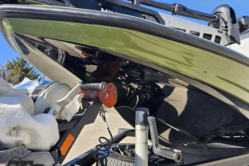 Slide: The Image of 2022 Skeeter FXR21 Apex boat on trailer, showcasing hull and winch details. - 22