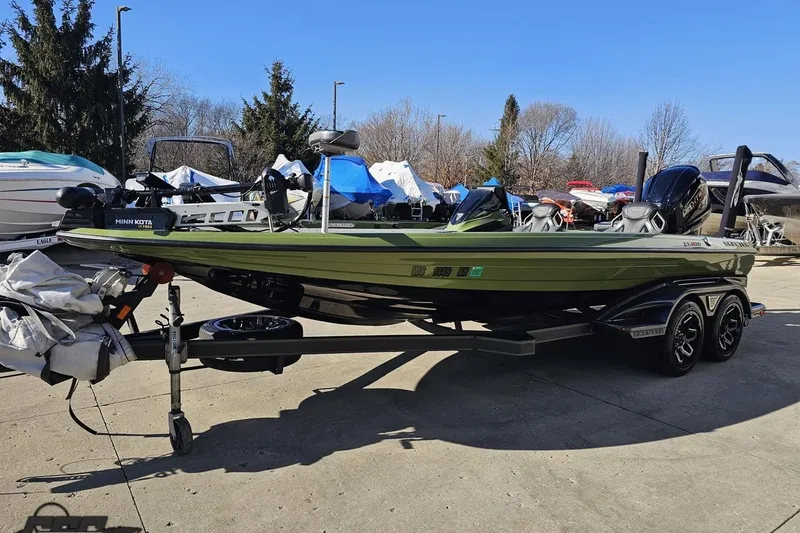 Slide: The Image of 2022 Skeeter FXR21 Apex boat on trailer, parked outdoors in a marina. - 24
