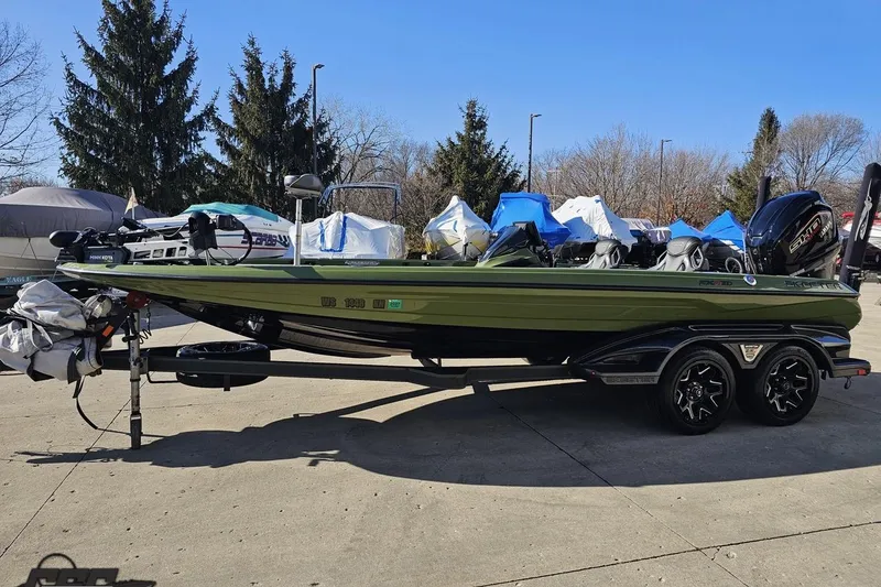 Slide: The Image of 2022 Skeeter FXR21 Apex bass boat on trailer, parked outdoors. - 25