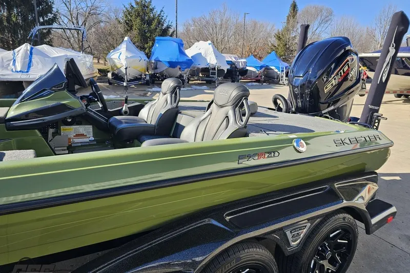 Slide: The Image of 2022 Skeeter FXR21 Apex boat with sleek design and powerful engine in outdoor setting. - 29