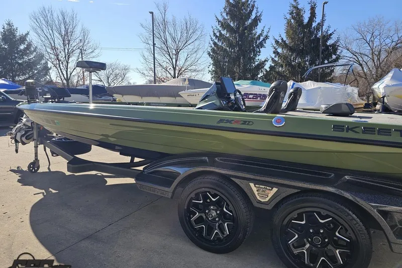 Slide: The Image of 2022 Skeeter FXR21 Apex boat on trailer, parked outdoors in sunny weather. - 34