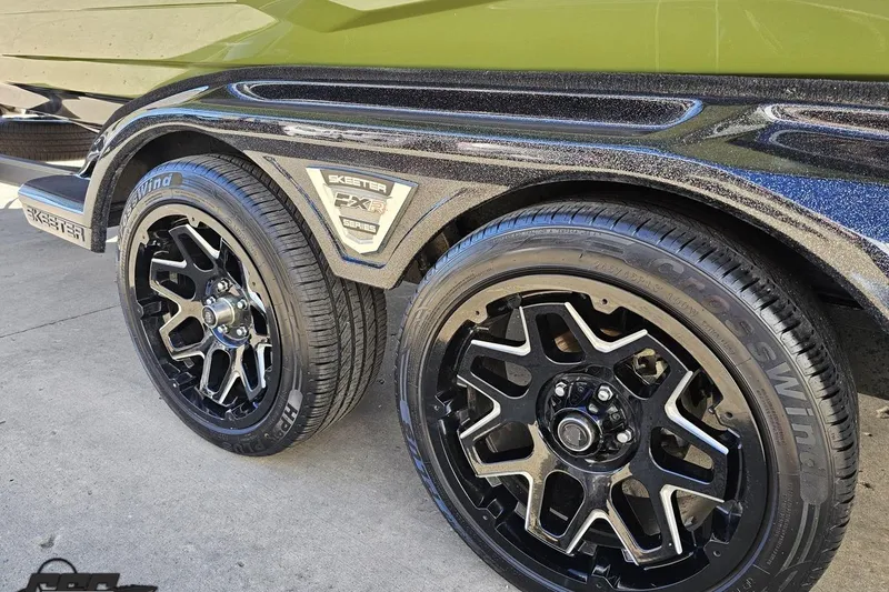 Slide: The Image of 2022 Skeeter FXR21 Apex trailer with black alloy wheels and branded fender. - 36