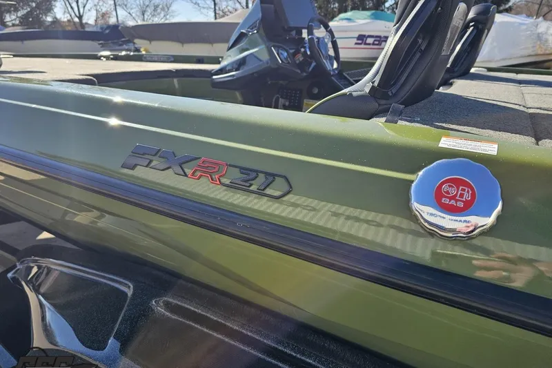 Slide: The Image of 2022 Skeeter FXR21 Apex boat, green exterior, close-up of model logo and gas cap. - 37
