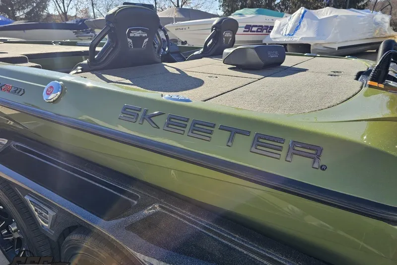 Slide: The Image of 2022 Skeeter FXR21 Apex boat, green exterior, close-up of branding and deck. - 38