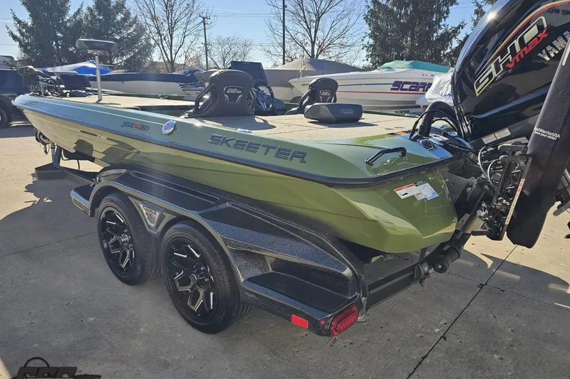 Slide: The Image of 2022 Skeeter FXR21 Apex boat with Yamaha engine on trailer, parked outdoors. - 39