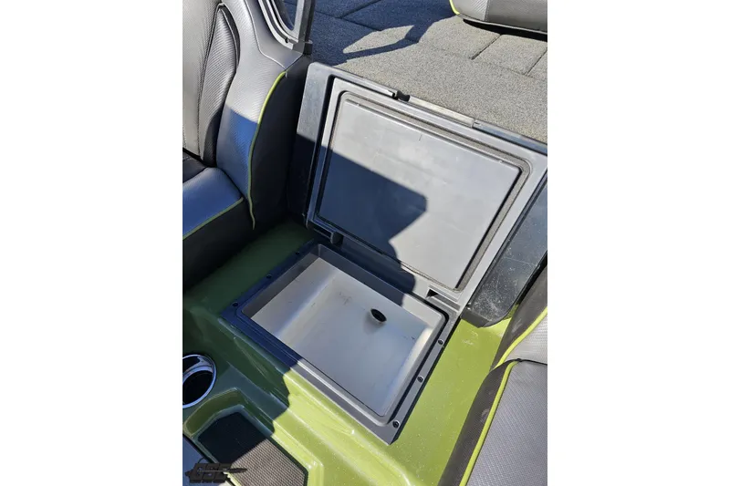 Slide: The Image of 2022 Skeeter FXR21 Apex boat storage compartment with open lid, showcasing interior space. - 58