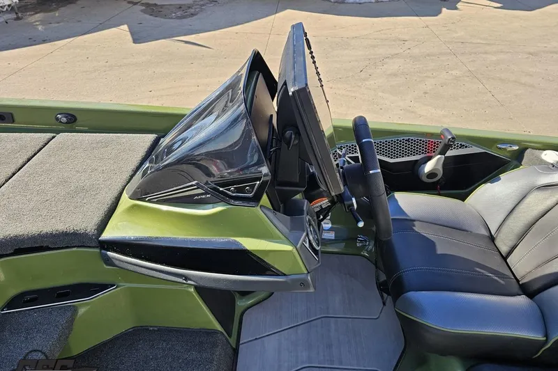 Slide: The Image of 2022 Skeeter FXR21 Apex boat interior with steering wheel and dashboard controls. - 59