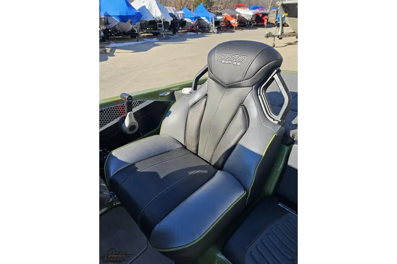 Slide: The Image of 2022 Skeeter FXR21 Apex boat seat, black and gray design, outdoor setting. - 60