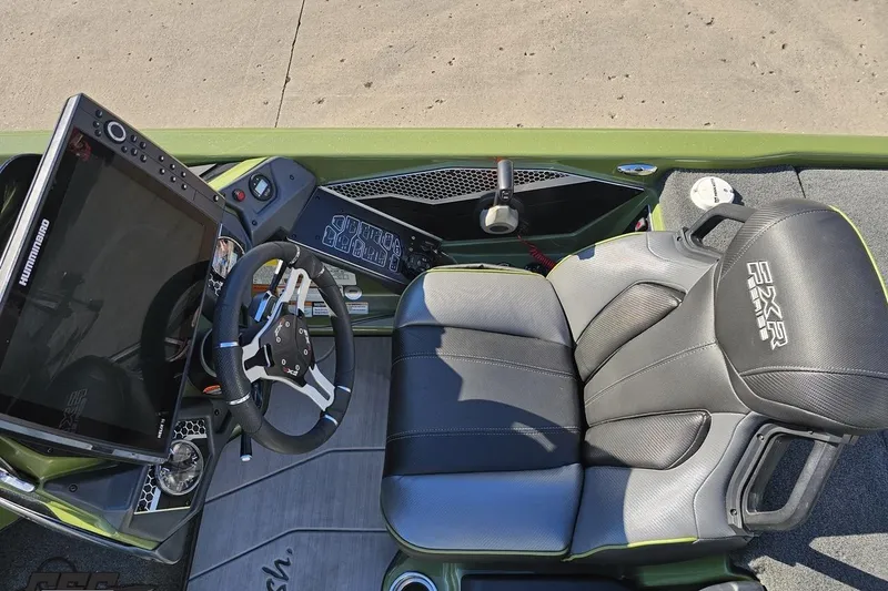 Slide: The Image of 2022 Skeeter FXR21 Apex boat cockpit with steering wheel and advanced control panel. - 61