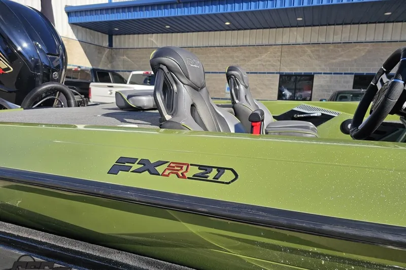 Slide: The Image of 2022 Skeeter FXR21 Apex boat in green with sleek design and comfortable seating. - 7