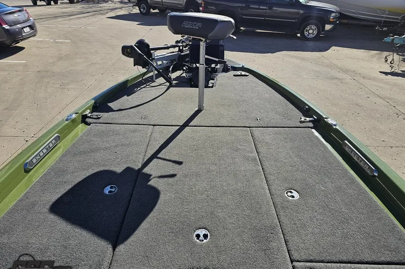 Slide: The Image of 2022 Skeeter FXR21 Apex boat deck with seating and equipment in a parking lot. - 71