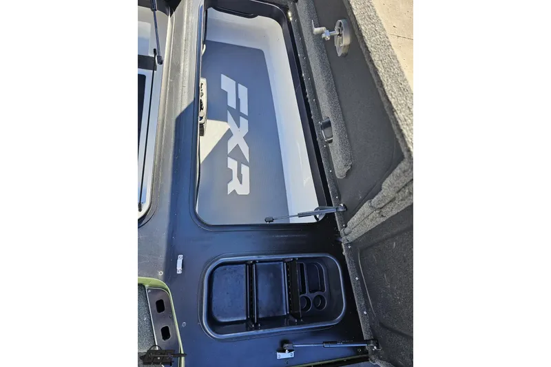 Slide: The Image of 2022 Skeeter FXR21 Apex boat storage compartment with FXR branding. - 74