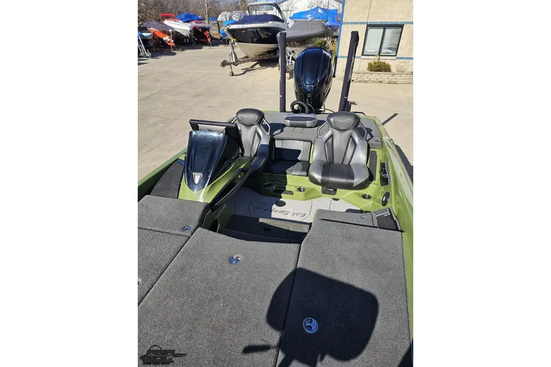Slide: The Image of 2022 Skeeter FXR21 Apex boat interior with seating and console, parked outdoors. - 83