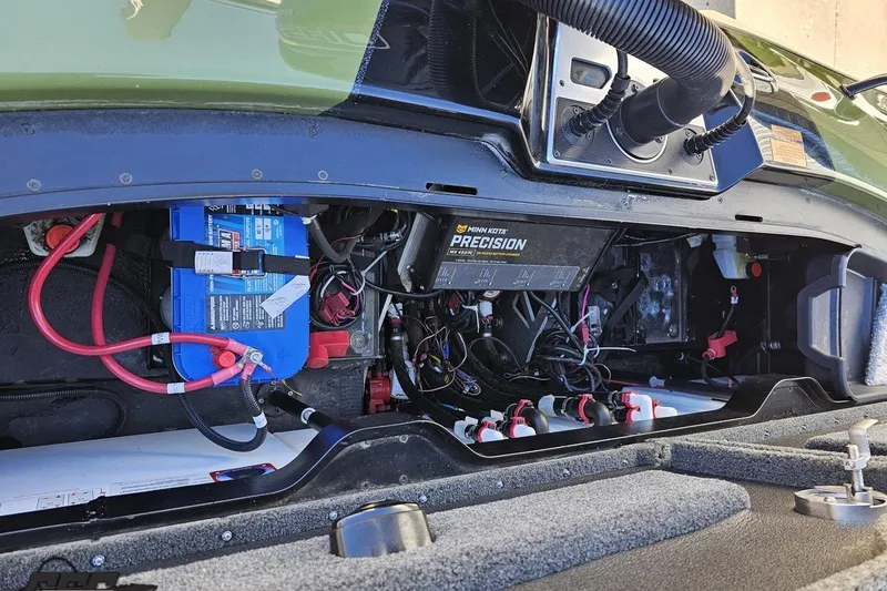 Slide: The Image of 2022 Skeeter FXR21 Apex boat battery compartment with wiring and Minn Kota Precision charger. - 87