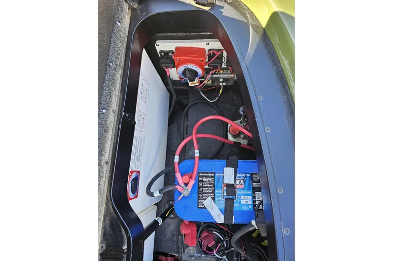 Slide: The Image of 2022 Skeeter FXR21 Apex boat battery compartment with wiring and components. - 88