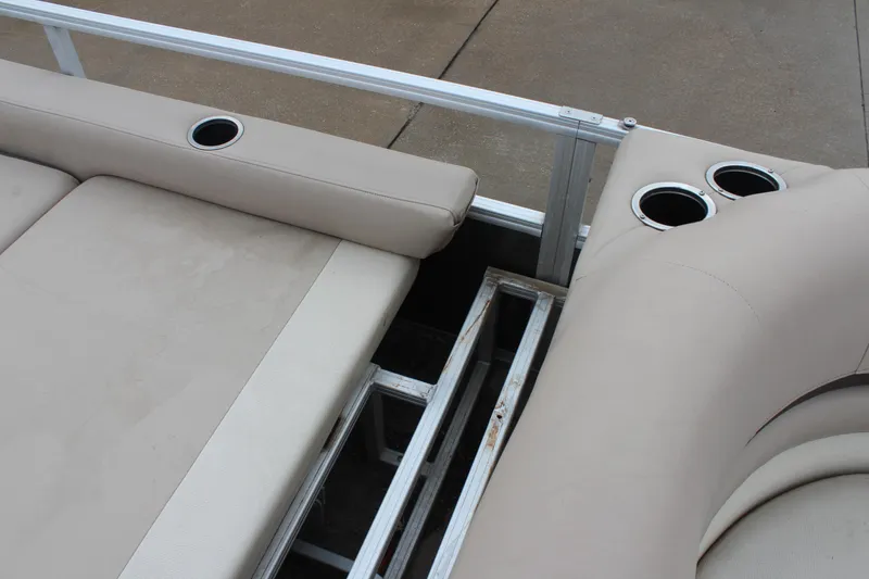 Slide: The Image of 2016 Sun Tracker Party Barge 24 XP3 interior with beige seating and cup holders. - 21