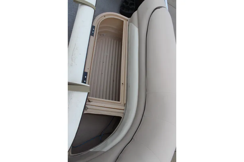 Slide: The Image of 2016 Sun Tracker Party Barge 24 XP3 storage compartment with beige seating. - 23