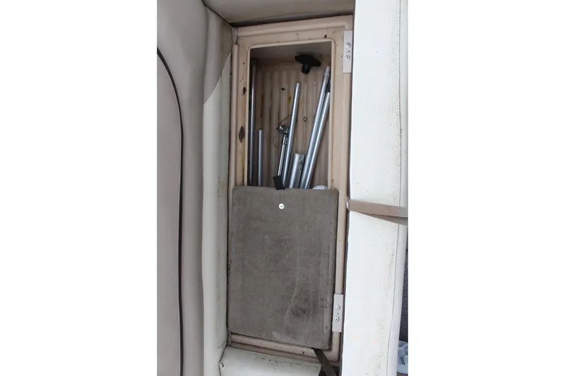 Slide: The Image of Storage compartment on 2016 Sun Tracker Party Barge 24 XP3 with metal poles. - 26