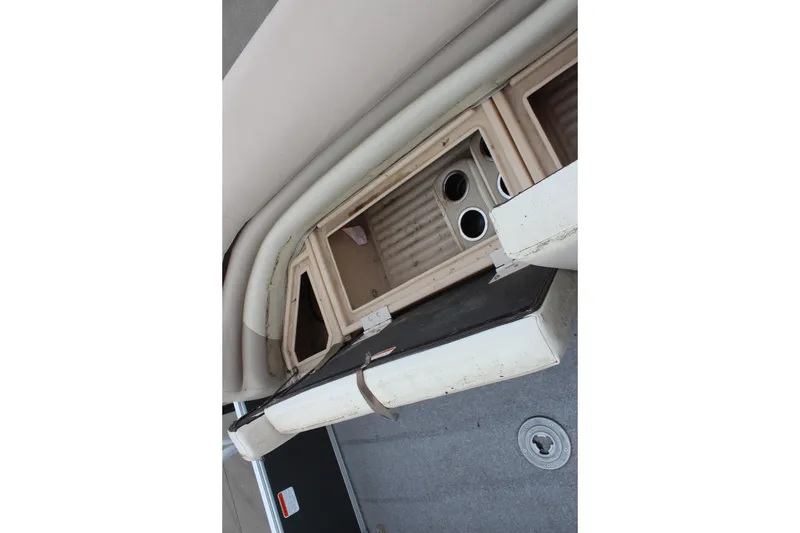 Slide: The Image of 2016 Sun Tracker Party Barge 24 XP3 interior storage compartment with cup holders. - 29
