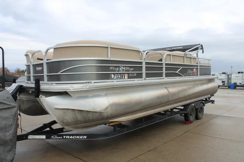 Slide: The Image of 2016 Sun Tracker Party Barge 24 XP3 pontoon boat on trailer, parked outdoors. - 3