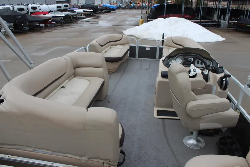 Slide: The Image of 2016 Sun Tracker Party Barge 24 XP3 interior with beige seating and helm. - 8