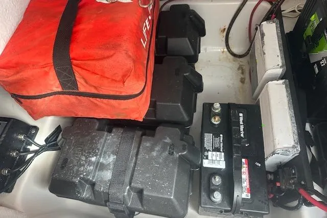 Slide: The Image of 2018 Tidewater 230 CC Adventure boat battery compartment with safety equipment. - 13