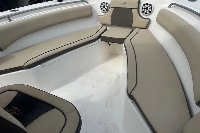 Slide: The Image of 2018 Tidewater 230 CC Adventure boat interior with beige seating and speakers. - 16