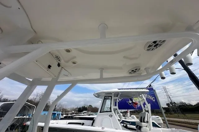 Slide: The Image of 2018 Tidewater 230 CC Adventure boat, featuring a detailed view of the T-top and speakers. - 21