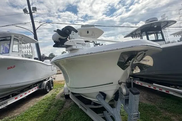 Slide: The Image of 2018 Tidewater 230 CC Adventure boat on trailer under cloudy sky. - 8
