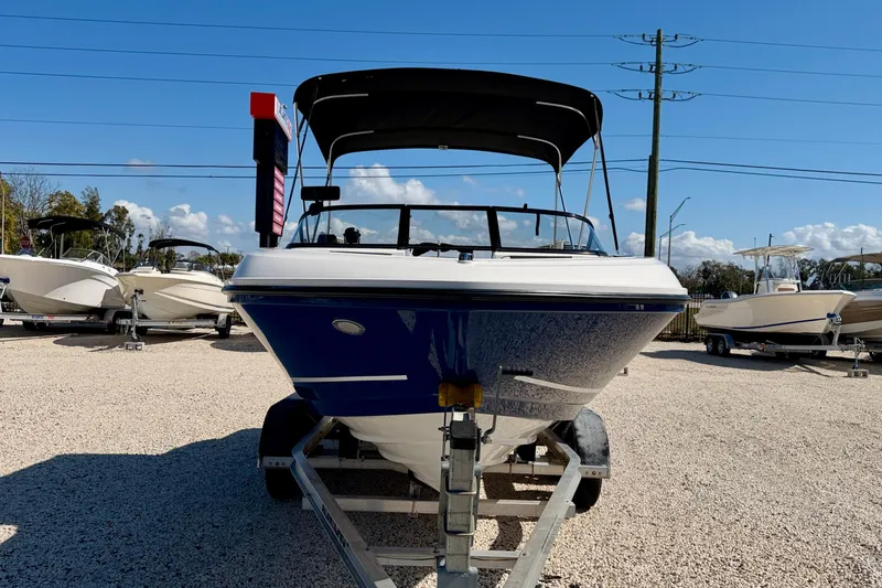 Slide: The Image of 2020 Bayliner VR5 Bowrider OB on trailer, displayed outdoors under clear blue sky. - 3