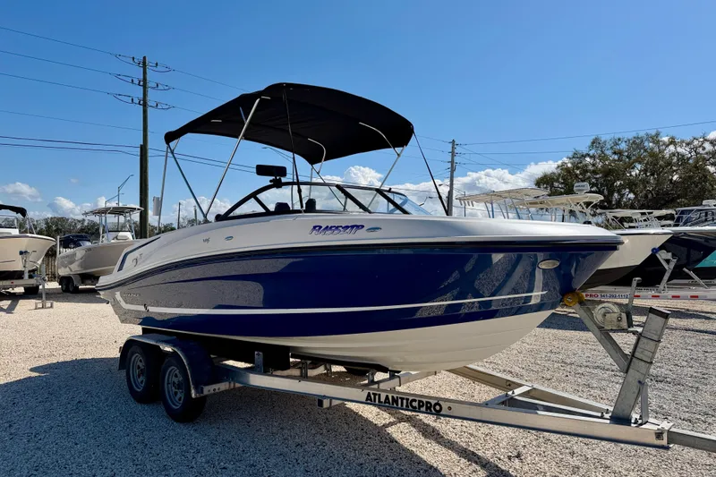 Slide: The Image of 2020 Bayliner VR5 Bowrider OB on trailer under clear blue sky. - 4