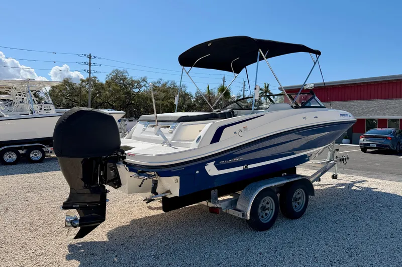 Slide: The Image of 2020 Bayliner VR5 Bowrider OB on trailer, parked outdoors under clear sky. - 5