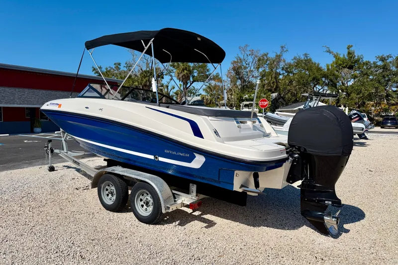 Slide: The Image of 2020 Bayliner VR5 Bowrider OB on trailer, blue and white, parked outdoors. - 7