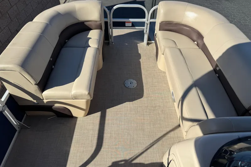 Slide: The Image of 2019 Sun Tracker SportFish 22 DLX pontoon boat with beige seating and spacious deck. - 10