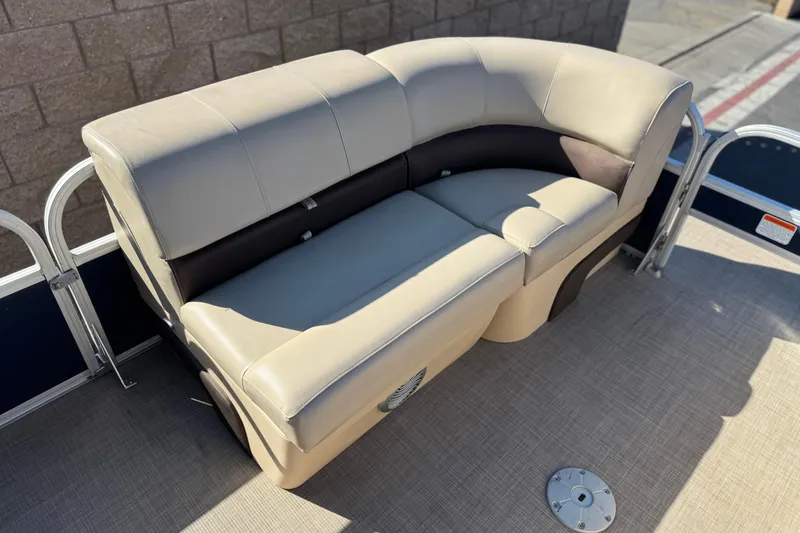 Slide: The Image of 2019 Sun Tracker SportFish 22 DLX boat with beige cushioned seating. - 11