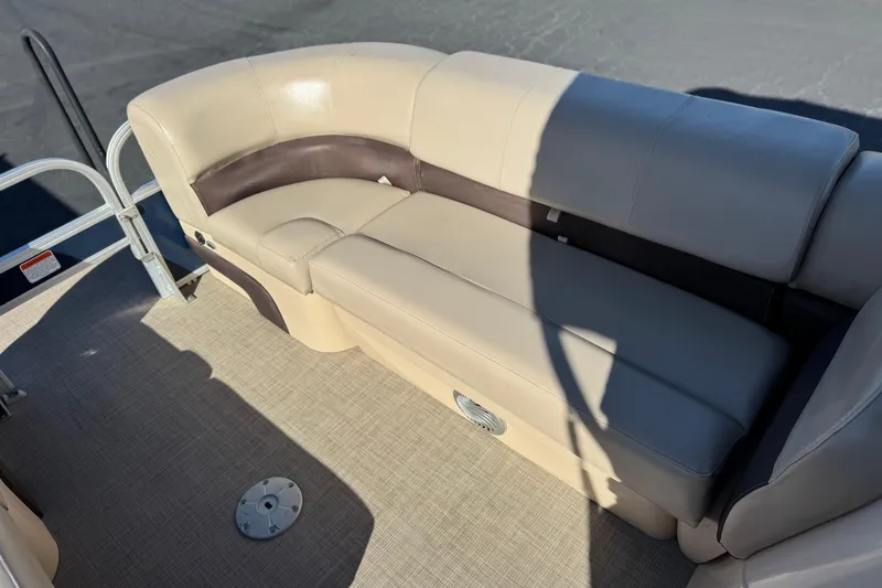 Slide: The Image of 2019 Sun Tracker SportFish 22 DLX boat interior with beige seating and carpeted floor. - 12