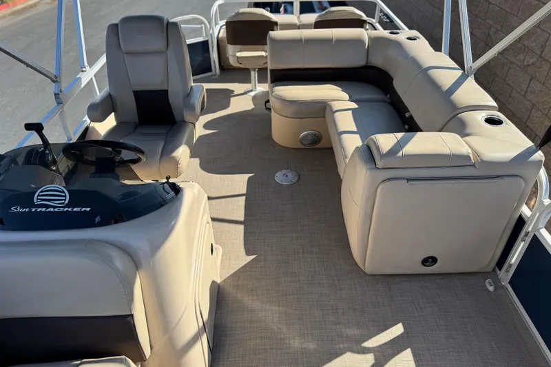 Slide: The Image of 2019 Sun Tracker SportFish 22 DLX pontoon boat interior with beige seating and steering console. - 13