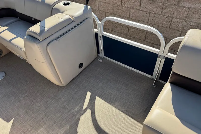 Slide: The Image of 2019 Sun Tracker SportFish 22 DLX interior with beige seating and carpeted floor. - 14
