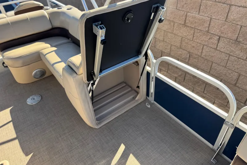 Slide: The Image of 2019 Sun Tracker SportFish 22 DLX boat interior with open storage compartment. - 15