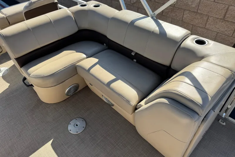 Slide: The Image of 2019 Sun Tracker SportFish 22 DLX boat seating with cup holders and speaker. - 16