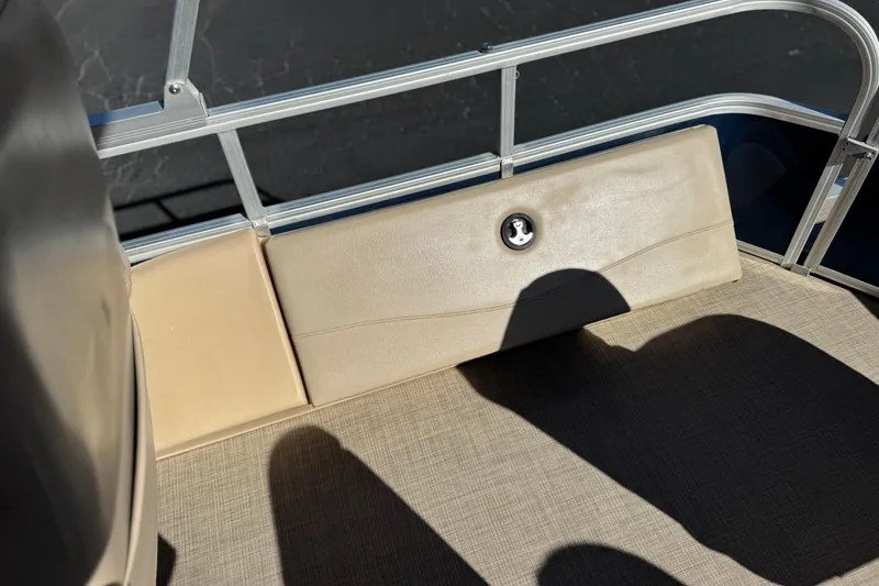 Slide: The Image of 2019 Sun Tracker SportFish 22 DLX boat interior with beige seating and metal railing. - 18