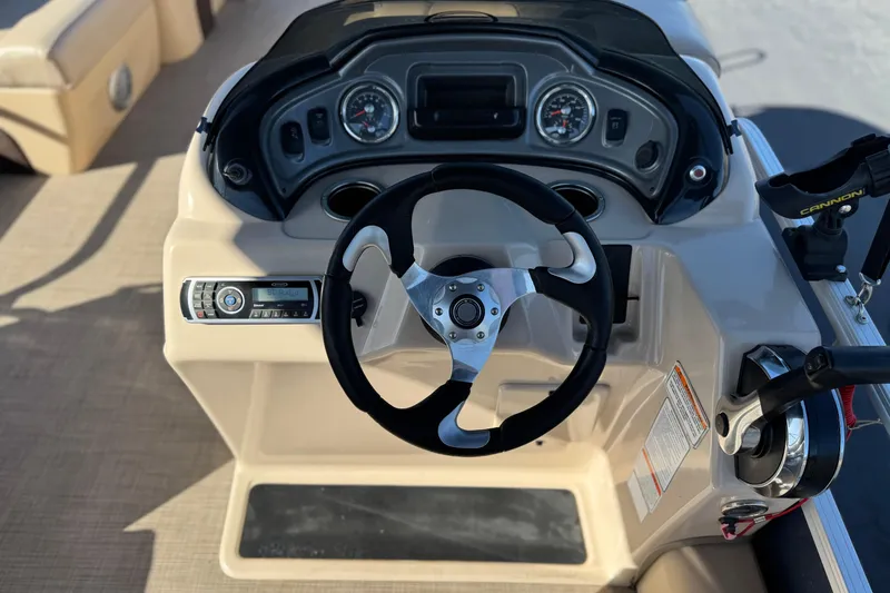 Slide: The Image of Steering console of 2019 Sun Tracker SportFish 22 DLX boat with gauges and controls. - 26