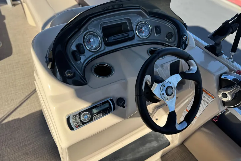 Slide: The Image of 2019 Sun Tracker SportFish 22 DLX boat dashboard with steering wheel and controls. - 27